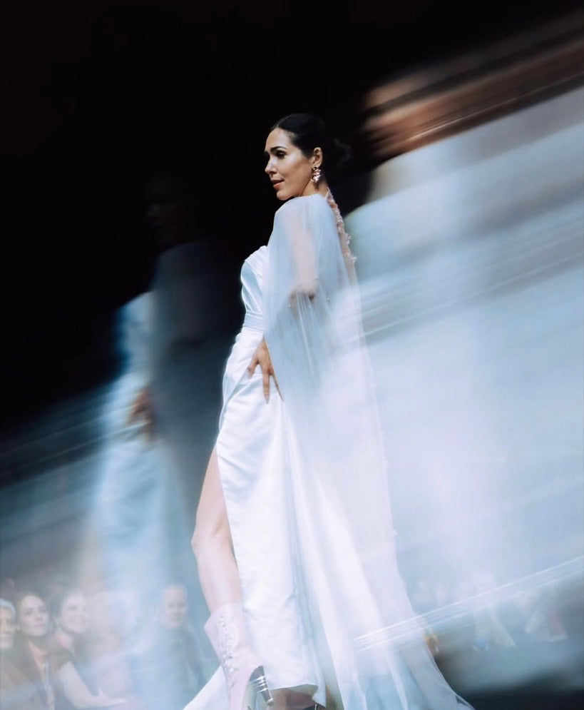 White gown and flowing cape captured in motion